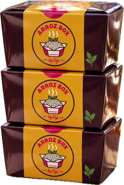 Three aubergine Arroz Box rice boxes with mustard-gold labels, stacked